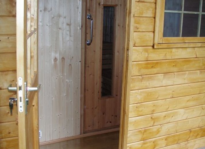 Chalet du bois in Biron, Ardennes with an inviting terrace surrounded by green nature.