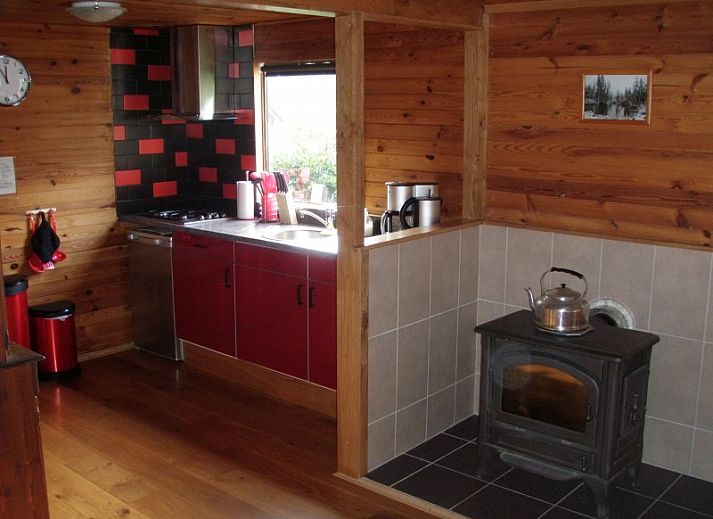 Chalet du bois in Biron, Ardennes with an inviting terrace surrounded by green nature.