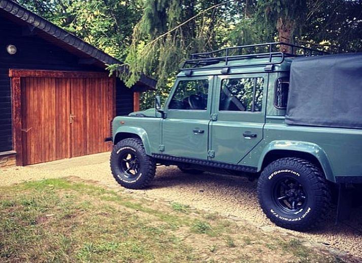Cottage in Our, Ardennes, Belgium with stone facade and terrace, surrounded by nature.