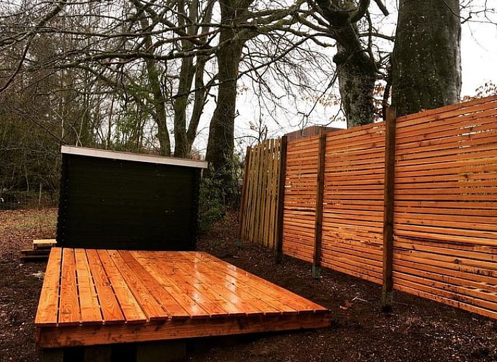 Cozy terrace at cottage in Our, Ardennes, Belgium with wooden seating.