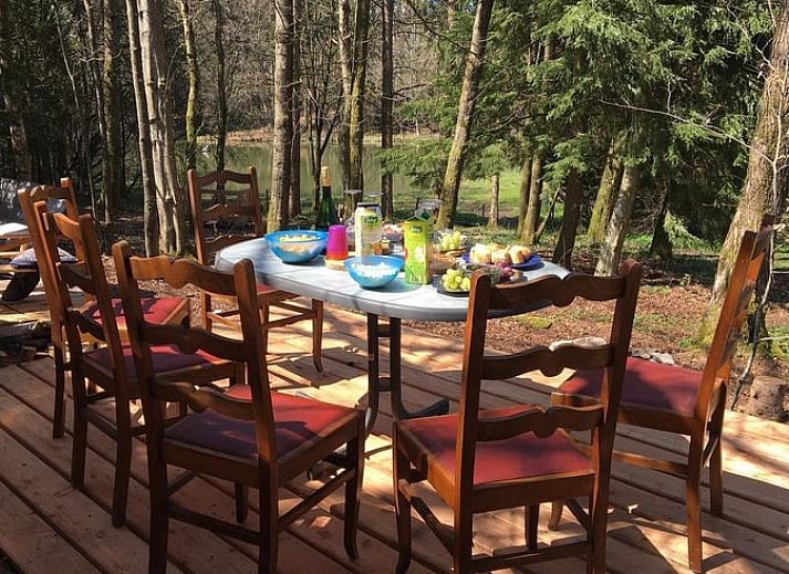 Cozy terrace at cottage in Our, Ardennes, Belgium with wooden seating.