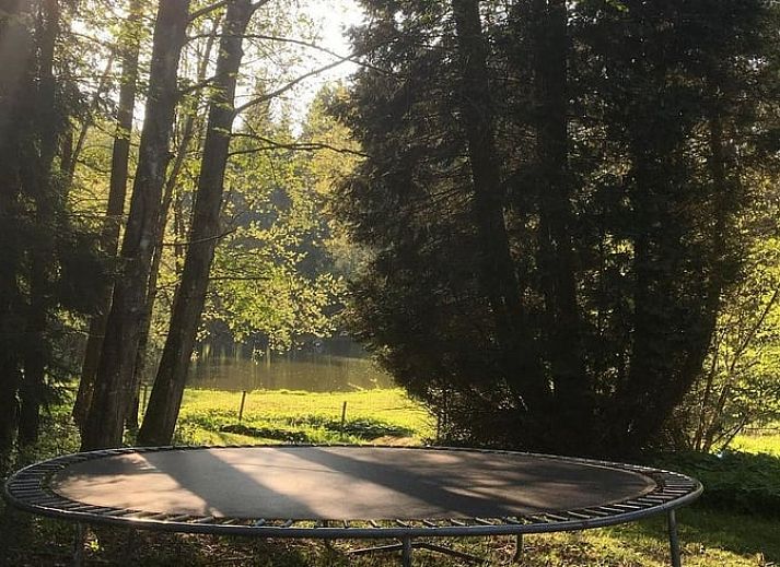 Cozy terrace at cottage in Our, Ardennes, Belgium with wooden seating.
