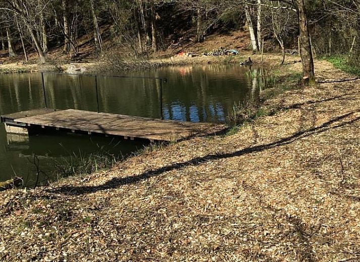 Tent next to all-terrain vehicle at cottage in Our, Ardennes, Belgium, perfect for camping enthusiasts.