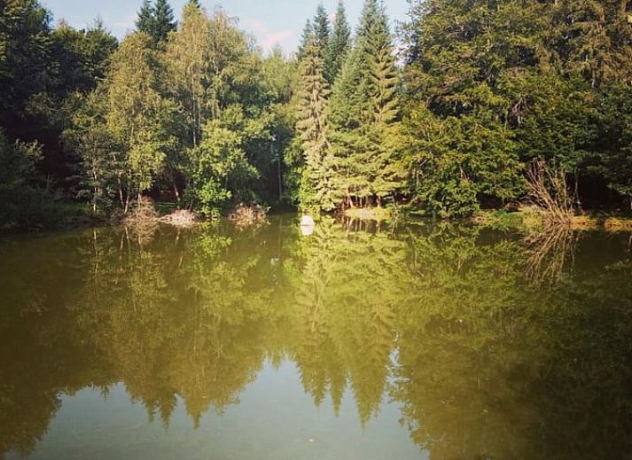 Tent next to all-terrain vehicle at cottage in Our, Ardennes, Belgium, perfect for camping enthusiasts.