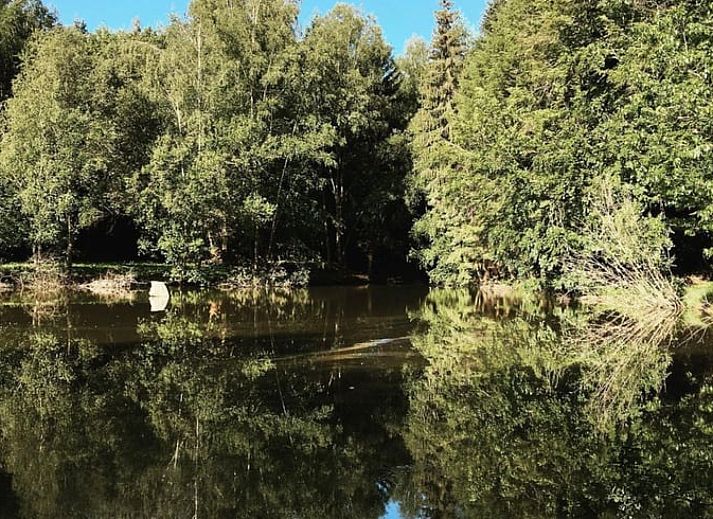 Tent next to all-terrain vehicle at cottage in Our, Ardennes, Belgium, perfect for camping enthusiasts.
