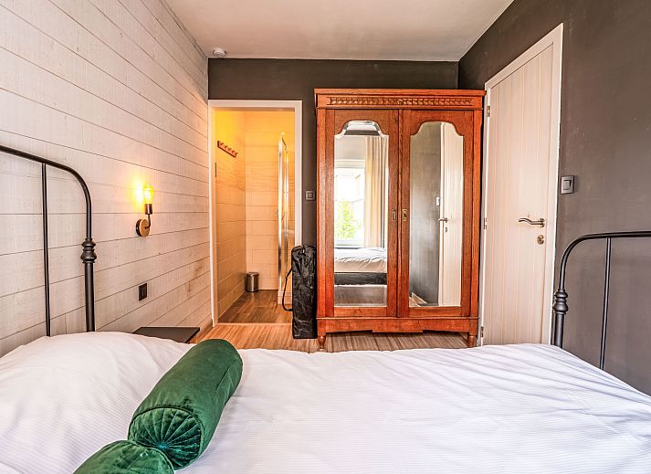 Gezellige woonkamer van Appartement BeachNest in Blankenberge, Belgische kust, met moderne inrichting en comfortabele zithoek.