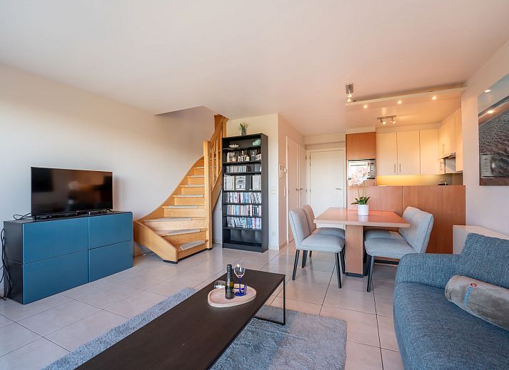 Cozy living room of Apartment Marebelle in Bredene, Belgian coast, overlooking terrace and nature for a relaxing vacation.