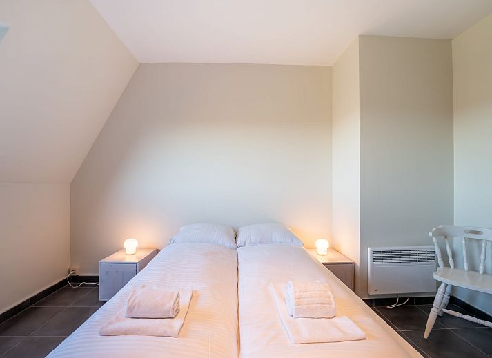 Cozy living room of Apartment Marebelle in Bredene, Belgian coast, overlooking terrace and nature for a relaxing vacation.