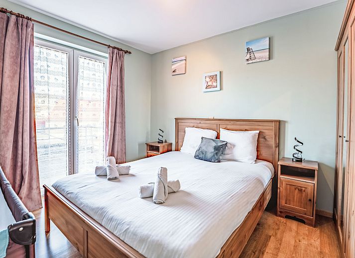 Cozy interior of the Zandloper Apartment with a balcony in Bredene, on the Belgian coast-an ideal vacation rental with a modern kitchen and sitting area.