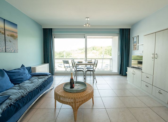 Bright living room of Apartment Lautrec in Bredene, Belgian coast, with a view of nature and a cozy sitting area.