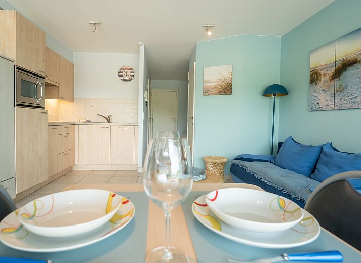 Bright living room of Apartment Lautrec in Bredene, Belgian coast, with a view of nature and a cozy sitting area.