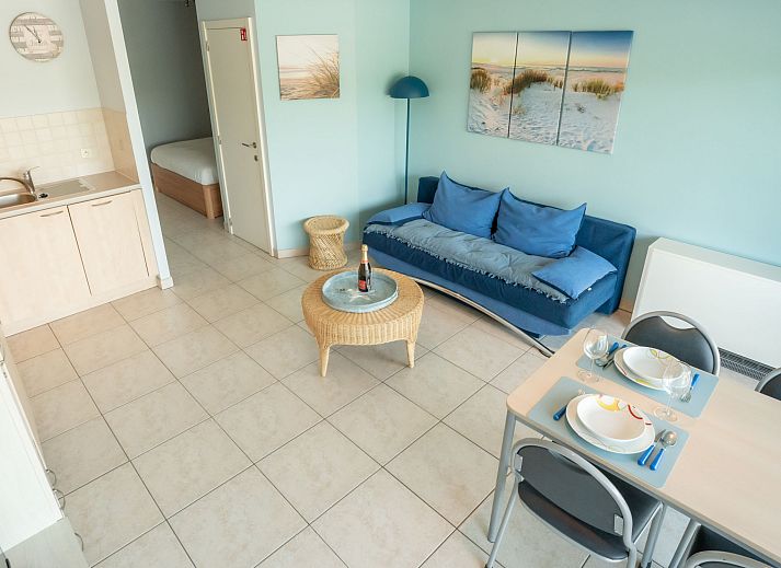 Cozy living room in Apartment Lautrec, Bredene, Belgian coast. Comfortable indoor space with a view of the green surroundings.