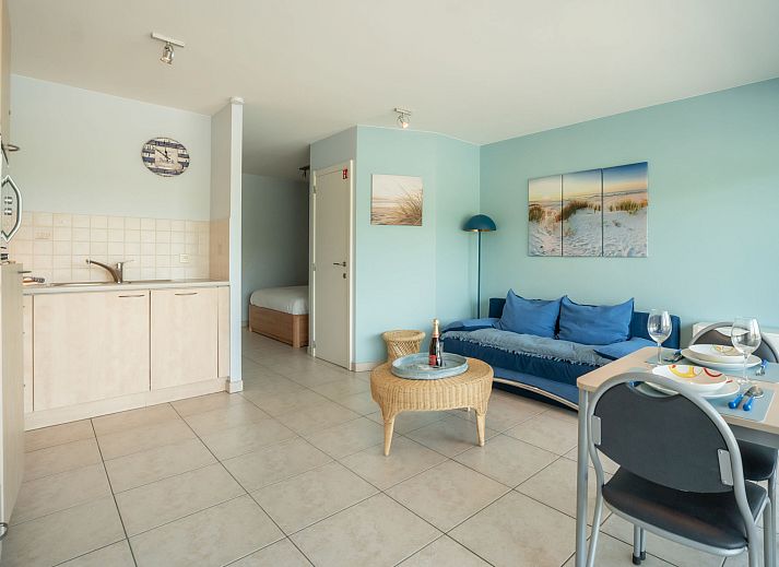 Cozy living room in Apartment Lautrec, Bredene, Belgian coast. Comfortable indoor space with a view of the green surroundings.