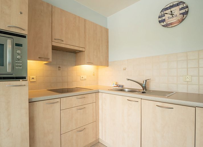 Cozy indoor space of Apartment Lautrec in Bredene on the Belgian coast, with modern kitchen and comfortable seating area.