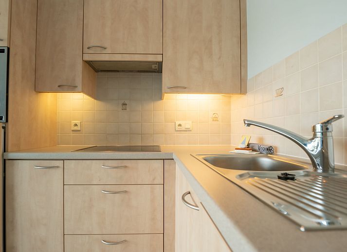 Cozy indoor space of Apartment Lautrec in Bredene on the Belgian coast, with modern kitchen and comfortable seating area.