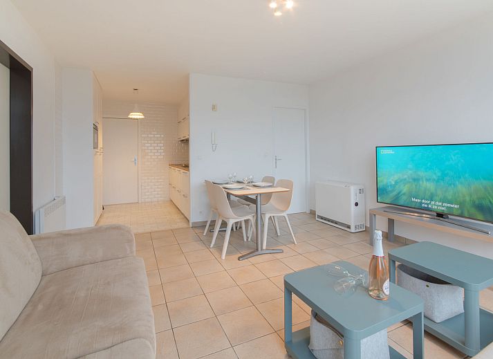 Cozy living room of Apartment Seaview 2 in Bredene, Belgian coast, with panoramic city views and comfortable seating area.