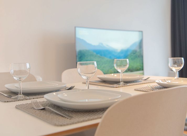 Cozy living room of Apartment Seaview 2 in Bredene, Belgian coast, with panoramic city views and comfortable seating area.