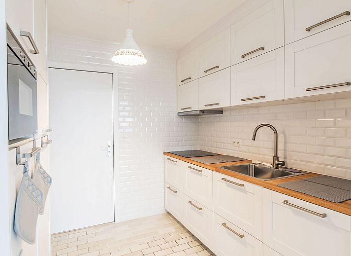 Cozy living room of Apartment Seaview 2 in Bredene, Belgian coast, with panoramic city views and comfortable seating area.