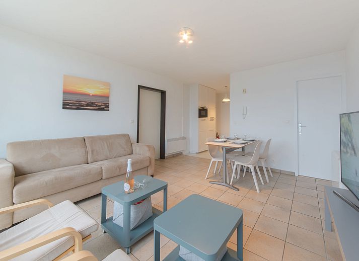 Cozy living room of Apartment Seaview 2 in Bredene, Belgian coast, with panoramic city views and comfortable seating area.