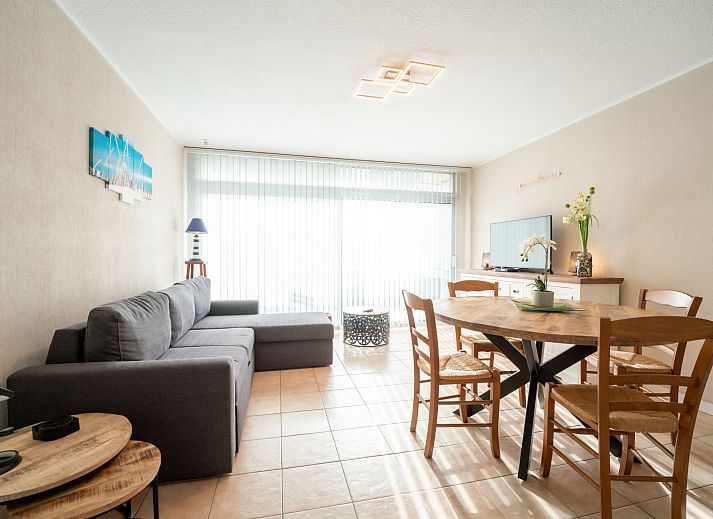 Cozy living room of Apartment Astrid 62/101 in Bredene, Belgian coast, with comfortable sitting area and dining area for a relaxing stay.