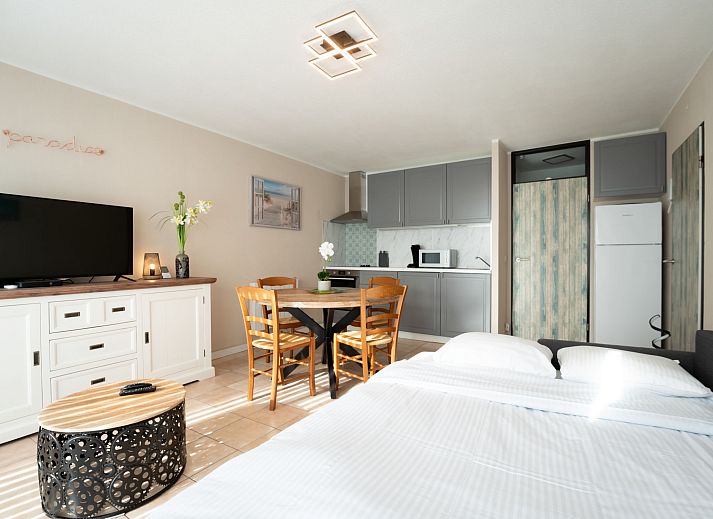 Cozy living room of Apartment Astrid 62/101 in Bredene, Belgian coast, with comfortable sitting area and dining area for a relaxing stay.