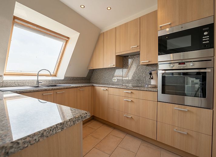 Cozy living room of Apartment Queen Mary in Bredene on the Belgian coast, with comfortable interior and views of the natural surroundings.