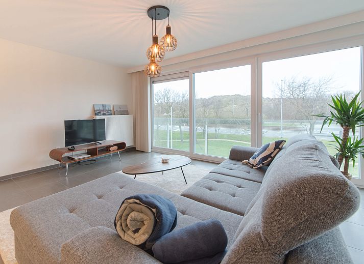 Stylish living room of Apartment Ocean in Bredene, Belgian coast, with modern decor and lots of natural light.