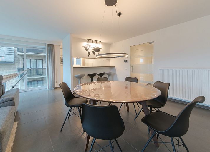 Stylish interior space of Apartment Ocean in Bredene, Belgian coast, with modern dining room and views of the surroundings.