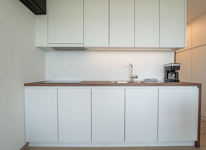 Modern interior space of Apartment Studio Zeezicht in Bredene, Belgian coast, with stylish kitchen and dining area.