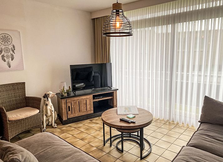 Cozy living room of Apartment 103 in Bredene, Belgian coast, with comfortable sitting area and modern kitchen.
