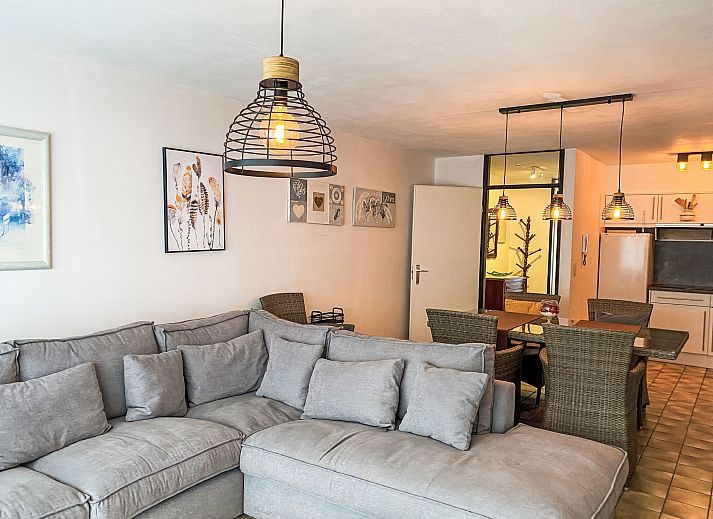 Cozy living room of Apartment 103 in Bredene, Belgian coast, with comfortable sitting area and modern kitchen.