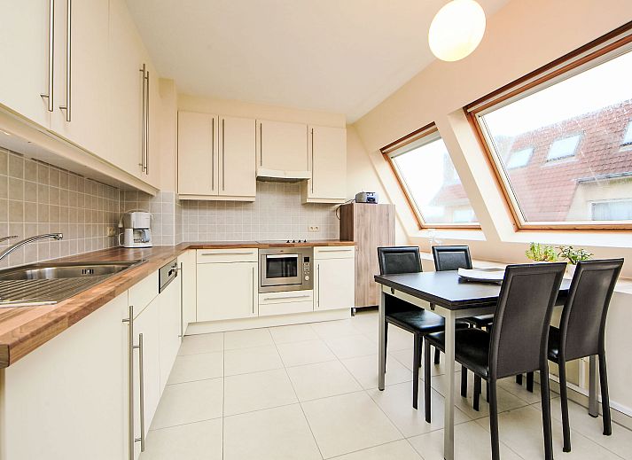 Bright interior space of Apartment Residentie Havenhuys in Bredene on the Belgian coast, with modern kitchen and cozy sitting area.