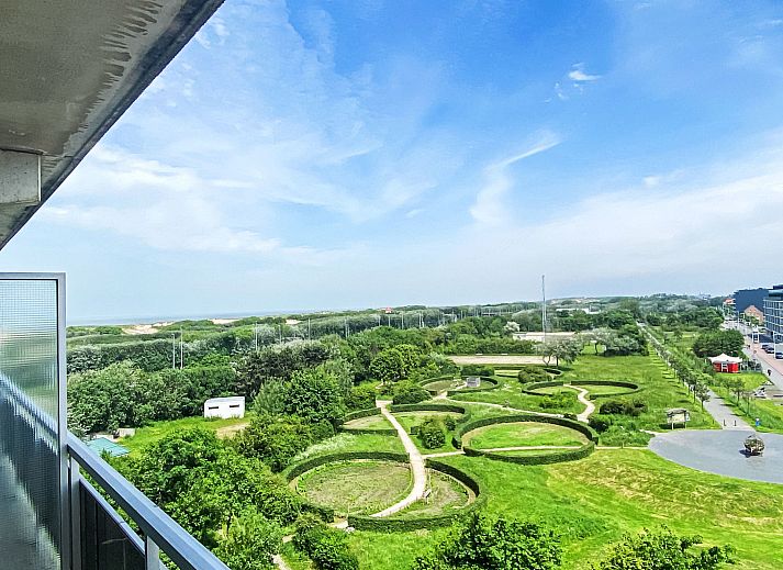 Cozy dining area in Apartment Residentie Astrid, Bredene, overlooking nature on the Belgian coast.