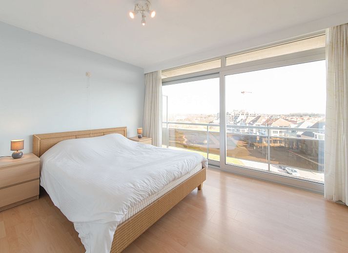 Cozy dining area in Apartment Residentie Astrid, Bredene, overlooking nature on the Belgian coast.