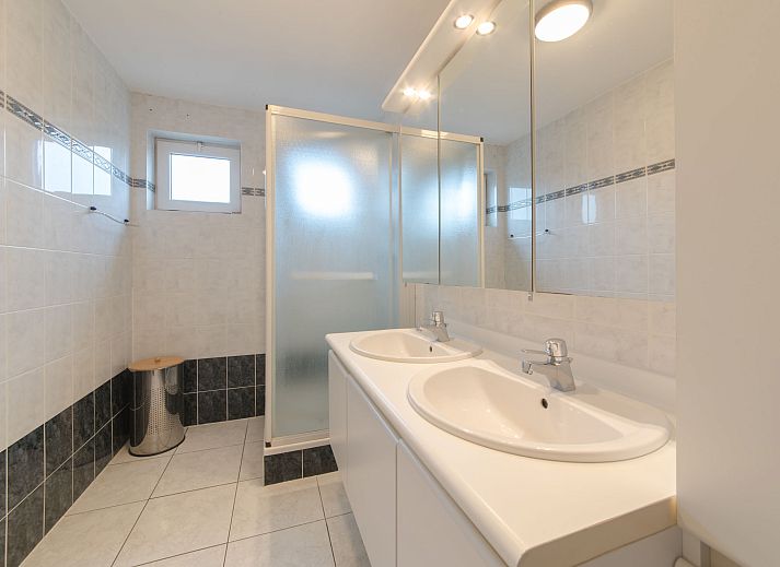 Cozy living room in Apartment De vakantieduinen aan zee, Bredene, Belgian coast, with modern furnishings and comfortable seating area.