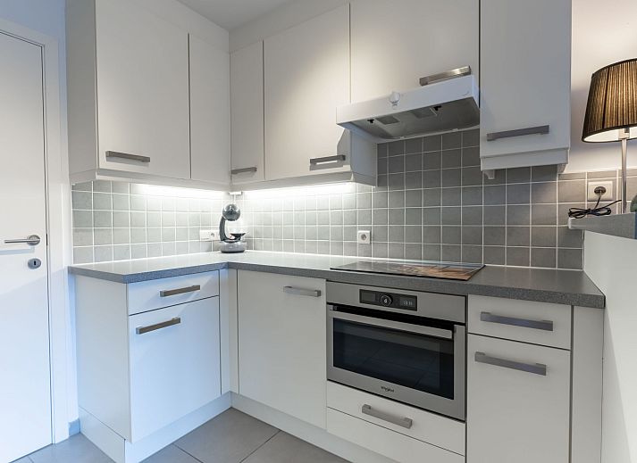 Modern living room and kitchen in Apartment Residentie Zandloper, Bredene, Belgian coast, with spacious sitting area and dining table.
