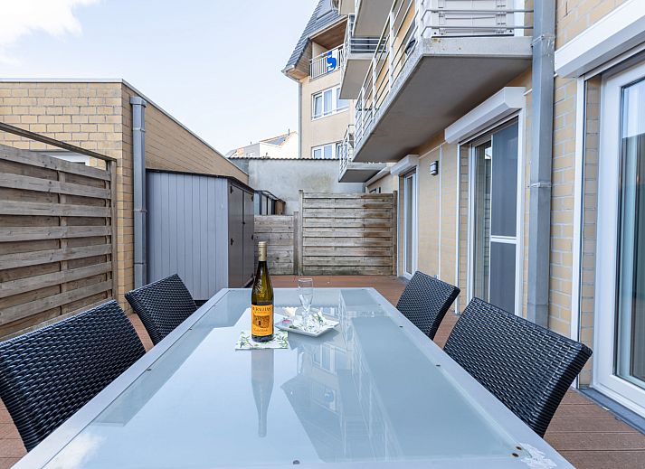 Enjoy the spacious terrace at Apartment Residentie Zandloper in Bredene, Belgian coast, ideal for relaxed outdoor dining.
