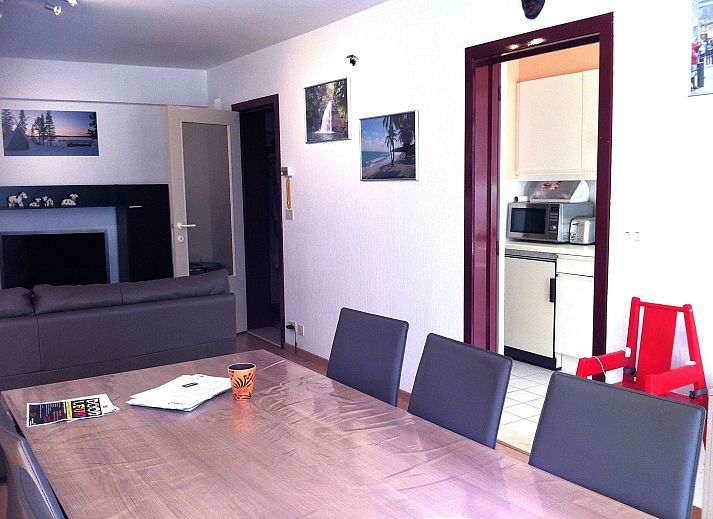 Cozy living room of Appartement Wohnung 'Wie zu Hause' in Middelkerke, Belgian coast, with comfortable sofa and colorful wall decoration.