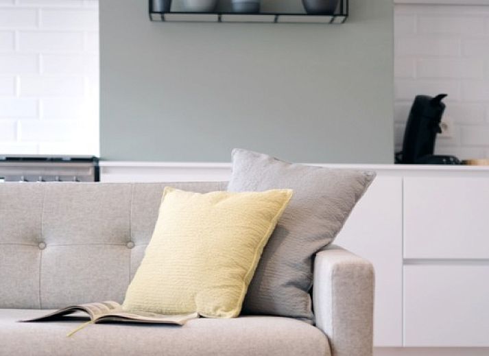 Stylish interior of WESTWIND Westende apartment on the Belgian coast, with modern mirror and pendant lamp.