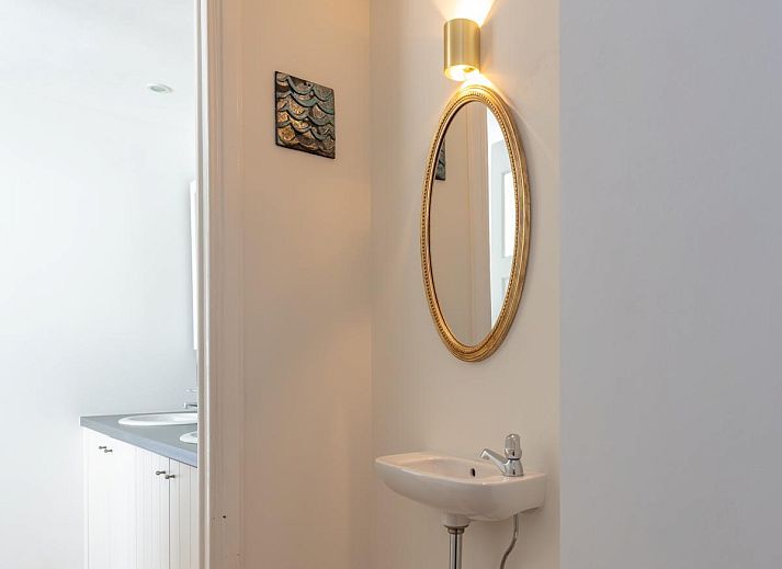 Sfeervolle slaapkamer in vakantiehuis Notre Dame, Nieuwpoort, Belgische kust, met twee bedden en een bureau onder een dakraam.