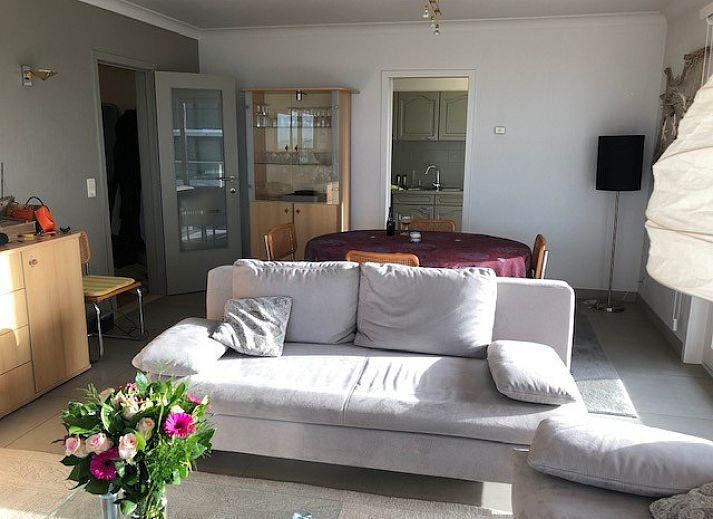 Cozy living room with sea view at 't Lange Lis apartment in De Panne, Belgian coast.