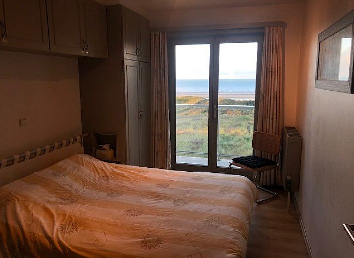 Cozy living room with sea view at 't Lange Lis apartment in De Panne, Belgian coast.
