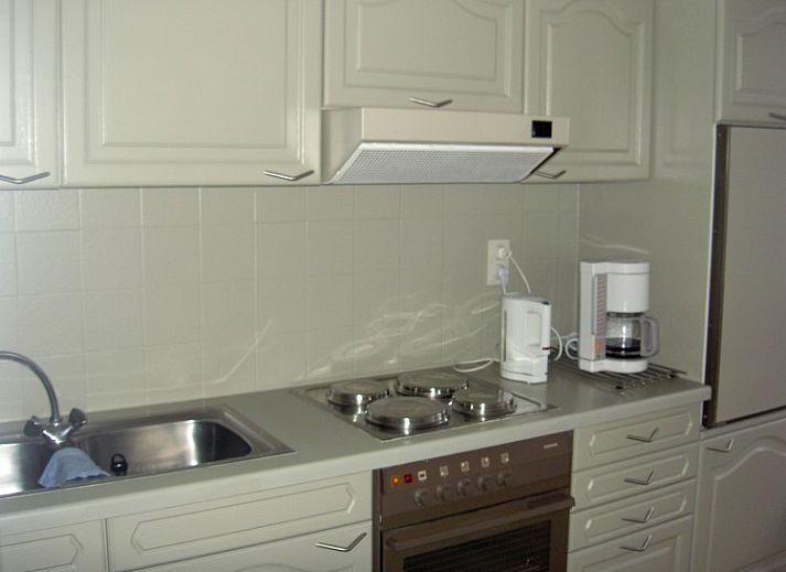 Comfortable indoor space with dining and sitting area in 't Lange Lis apartment, De Panne, Belgium.