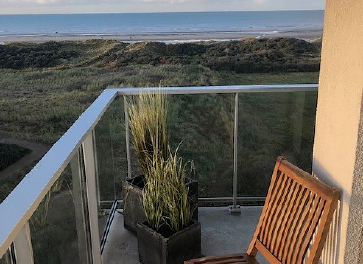 Comfortable indoor space with dining and sitting area in 't Lange Lis apartment, De Panne, Belgium.