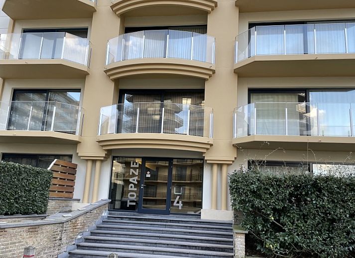 Cozy sitting area in vacation home Topaze, De Panne, with comfortable corner sofa and modern art.