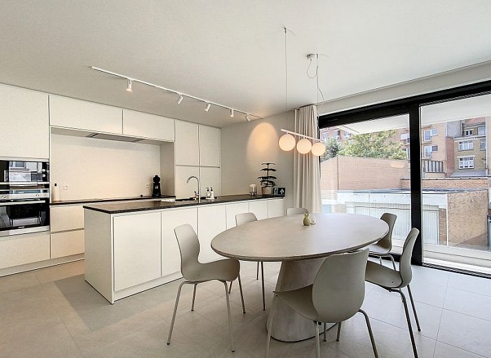 Modern living room in Apartment 'Asterias', De Panne, with comfortable seating area and large windows.