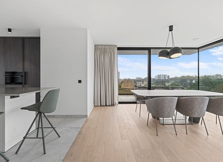 Luxury living room of Penthouse 'Ter Elst' in De Panne, Belgian coast, with panoramic views and modern furnishings for ultimate comfort.