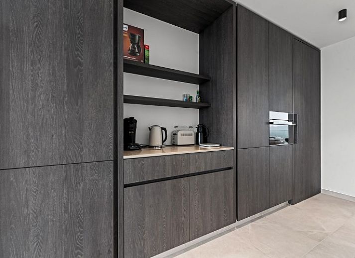 Luxury living room of Penthouse 'Ter Elst' in De Panne, Belgian coast, with panoramic views and modern furnishings for ultimate comfort.