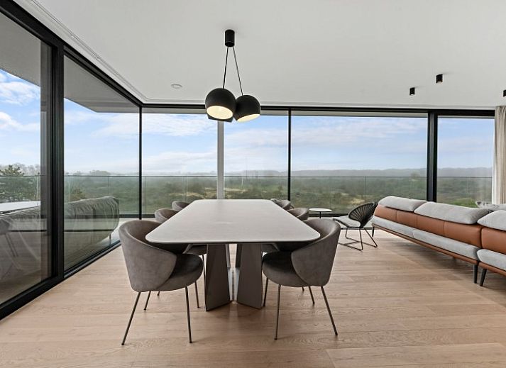 Luxury living room of Penthouse 'Ter Elst' in De Panne, Belgian coast, with panoramic views and modern furnishings for ultimate comfort.