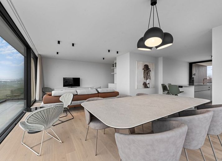 Luxury living room of Penthouse 'Ter Elst' in De Panne, Belgian coast, with panoramic views and modern furnishings for ultimate comfort.